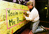 President 
Clinton autographing a banner from some special admirers