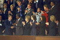 Photograph: First Lady Hillary Rodham Clinton and guests applaud Captain John Cherrey.
