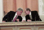Russian President Vladimir Putin makes a comment to the President before the signin ceremony.