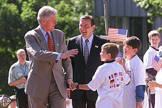 President Clinton and Chancellor Schroeder greet children in front of Cologne's Ludwig Museum, the site of Saturday morning's G-8 working sessions.
