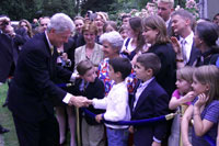 President Clinton greets a young admirer outside the ambassador's residence in Paris.