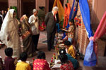 President Clinton observes students during a school event for the people of Joypura, US Embassy, Bangladesh.