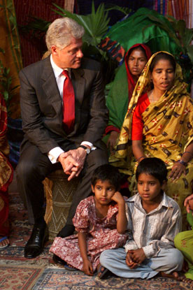 President Clinton listens to a woman from the Joypura village during the micro-credit event held at the us embassy, Bangladesh.