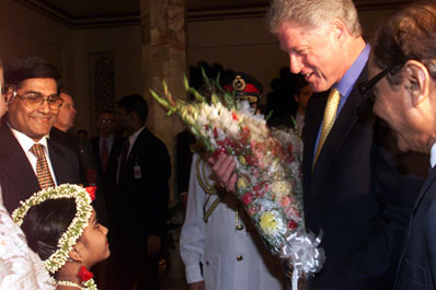 President Clinton is presented with flowers upon his arrival at the official dinner at Bangabhawan, Bangladesh.