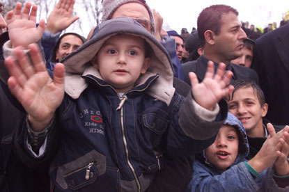 A young earthquake survivor in Izmit waves to the camera.