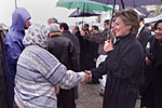 Mrs. Clinton greets a woman at the Dogukisla Tent City.
