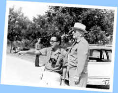 White House Photographer Yoichi R. Okamoto confers with President Lyndon Baines Johnson.